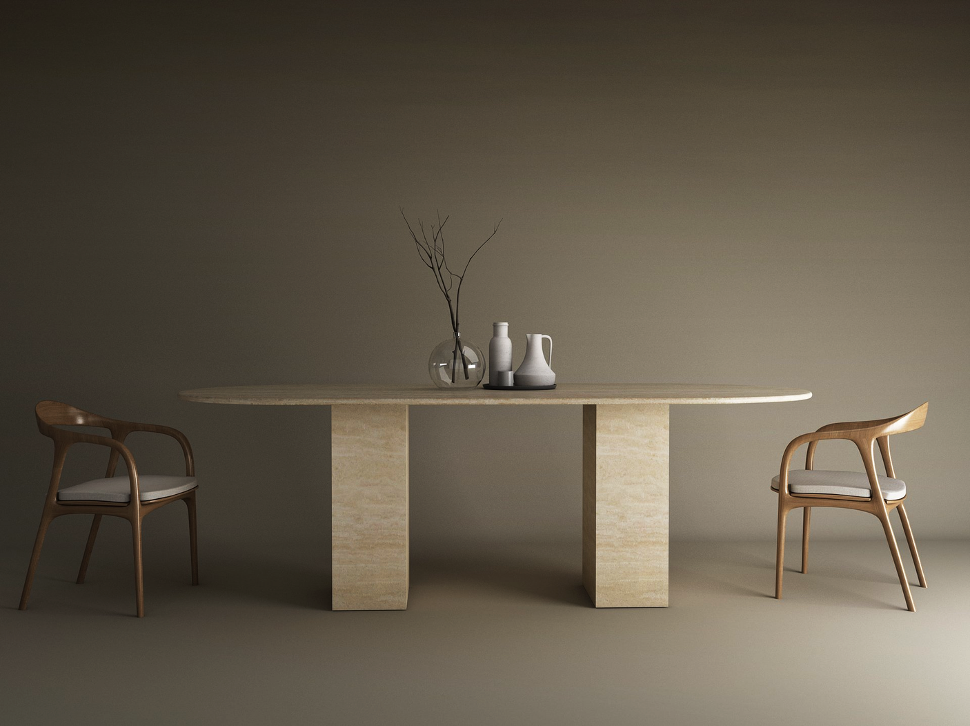 A minimalist room showcases the TRAVERTABLE Oval Travertine Dining Table with Rectangular Pedestal Base, two wooden chairs with white cushions, a glass vase with branches, and two white ceramic pitchers on the stone top against a taupe backdrop.
