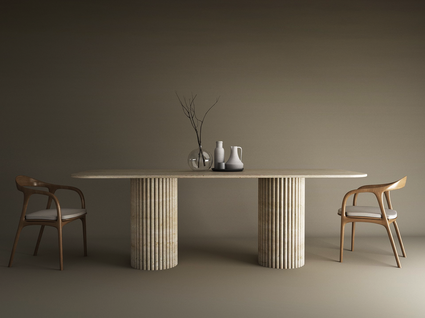 The TRAVERTABLE Rectangular Travertine Dining Table with Vertical Groove Base is paired with two cushioned wooden chairs. Its natural stone top holds a bare branch in a glass vase and three ceramic vessels, set against a neutral background.