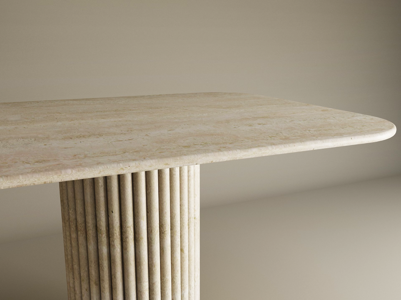 The TRAVERTABLE Rectangular Travertine Dining Table features a light beige stone top with rounded corners and a single cylindrical base with vertical grooves. This customizable table combines organic beauty and modern design. Neutral background.