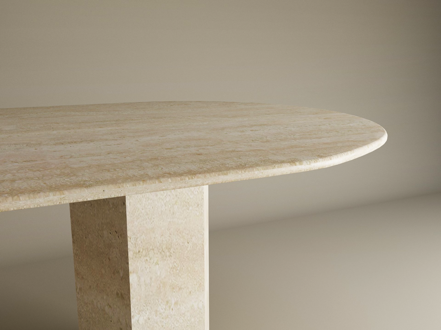 A close-up of the TRAVERTABLE Oval Travertine Dining Table features a beige natural stone top and a thick hexagonal pedestal base. Neutral background and floor enhance its minimalist look. Customizable options available.