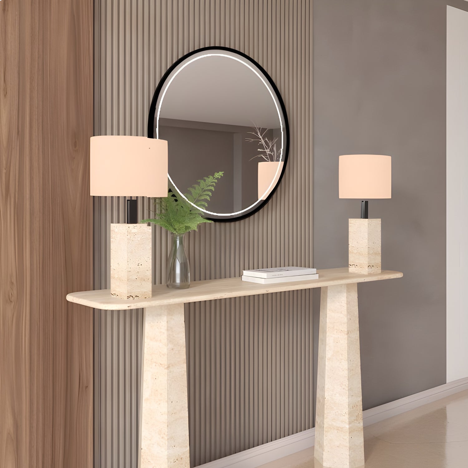 A Rectangular Travertine Console Table with Tapered Round Base by TRAVERTABLE displays two matching lamps, a vase with greenery, and a book. Placed against vertical wall paneling, it sits beneath a round mirror reflecting the room.