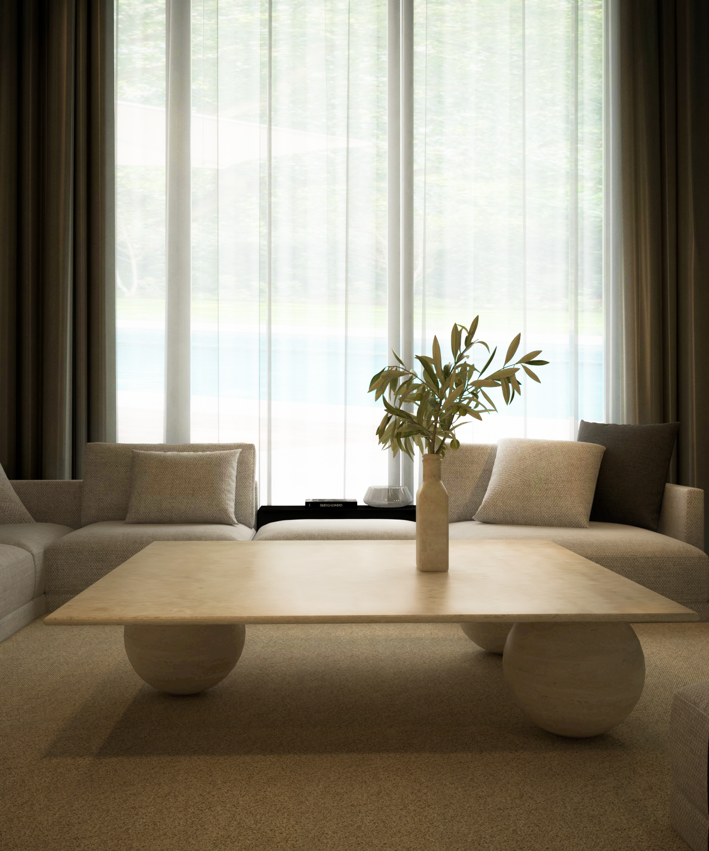A modern living room features two beige armchairs, sheer curtains, and the TRAVERTABLE Square Travertine Coffee Table with Stone Ball Base—its sculptural travertine design and a ceramic vase with green leaves add an organic touch.