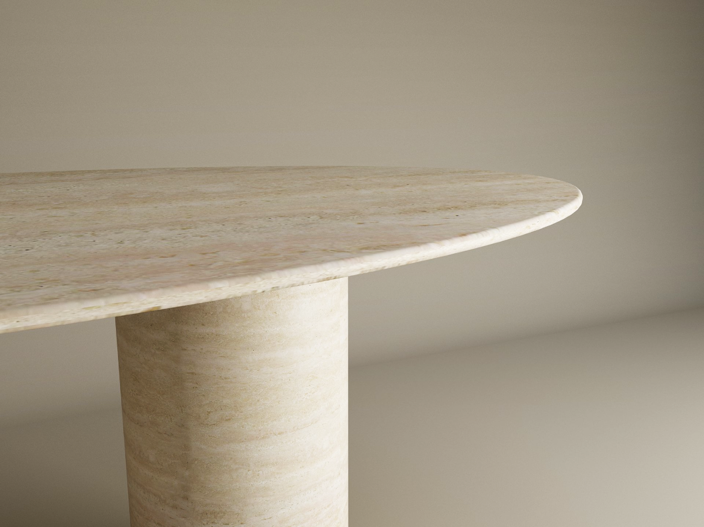 Close-up of the TRAVERTABLE Ellips Travertine Dining Table, showcasing a smooth light beige natural stone top and a pure travertine cylindrical base, set against a neutral background.