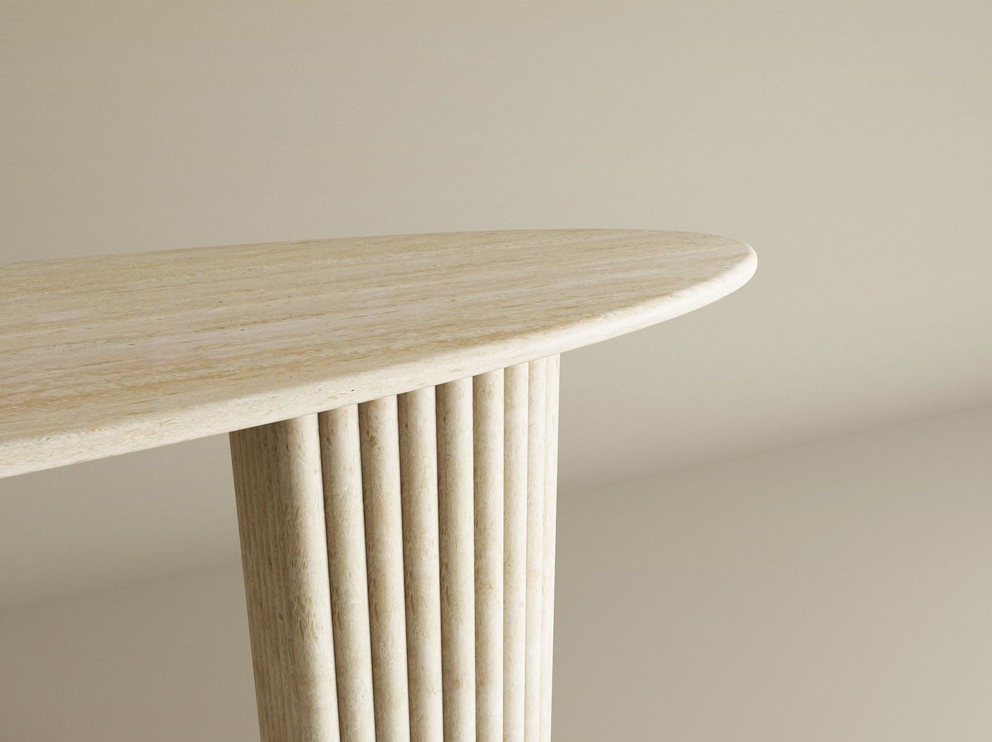 A close-up of the TRAVERTABLE Ellips Travertine Console Table with Fluted Round Base highlights its sculptural, solid stone form and refined luxury, set against a soft beige backdrop.
