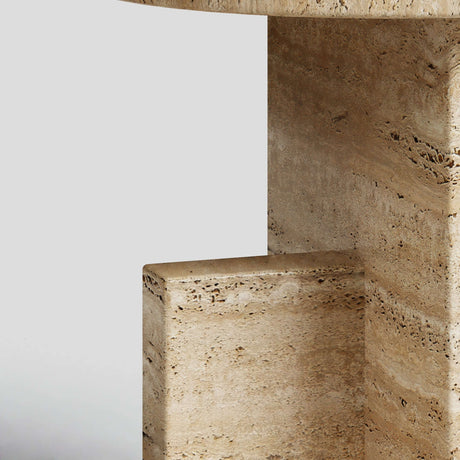 Close-up of the Travertine Scepter Side Table by Travertable, showcasing a geometric and modern design with a light beige, textured honed travertine surface. The unique architectural form features clean lines and right angles that highlight its natural patterns against a neutral background.