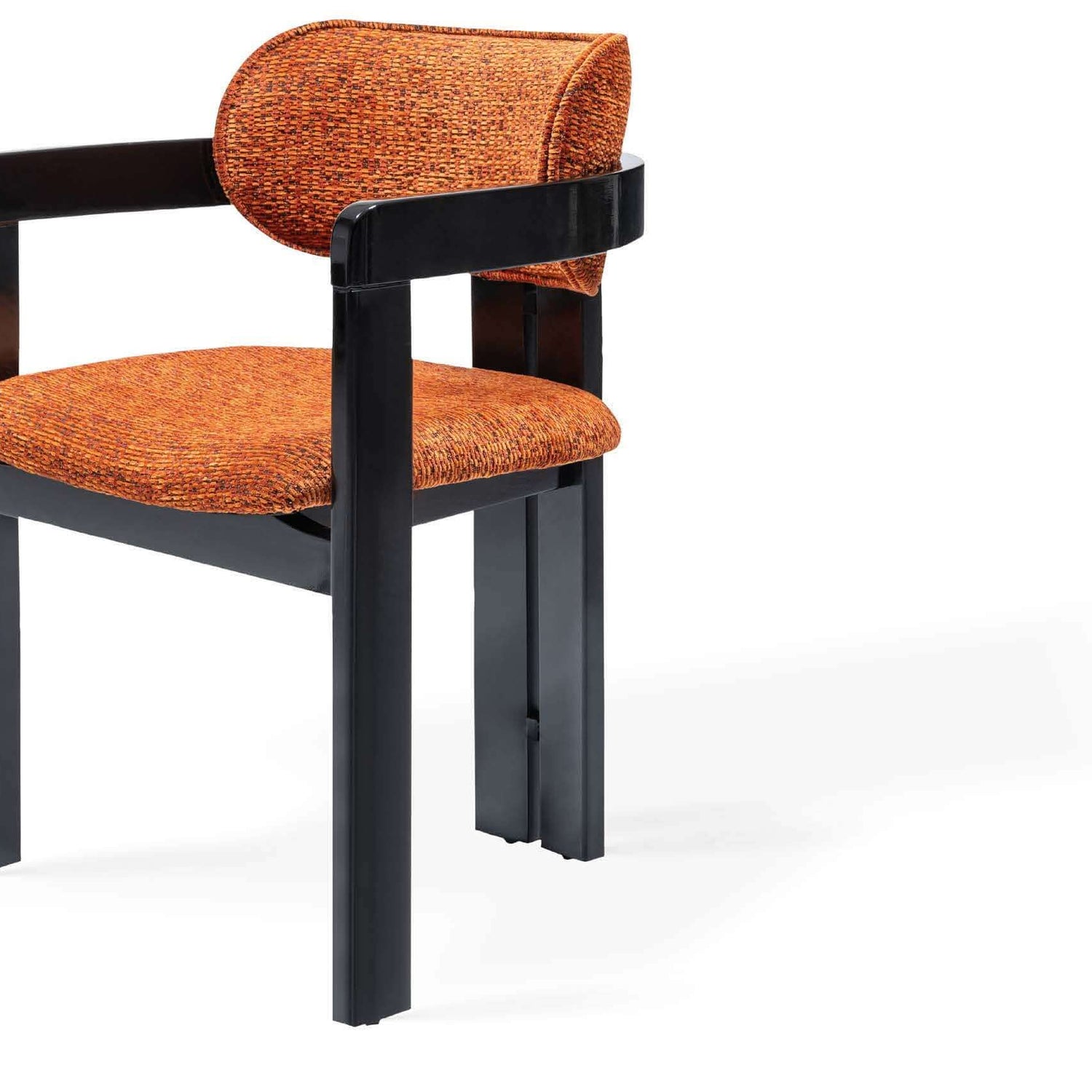 Discover the Solaris Retro Chair by Travertable, an ergonomic masterpiece with a black metal frame and an orange cushioned seat featuring a rounded backrest. Its sleek, minimalist design pops against a white backdrop.