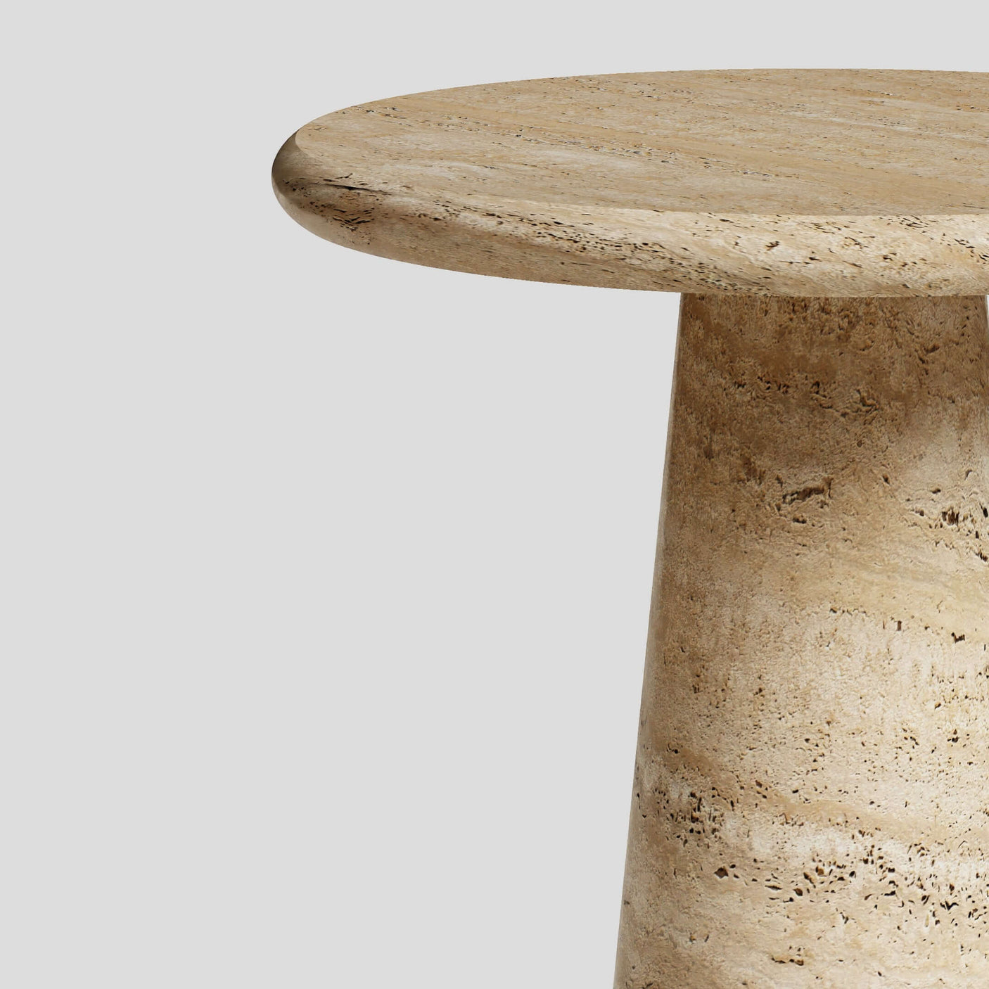 Close-up of the Travertables Tavolino Pietra Travertine Column Table, featuring a smooth, handcrafted round surface and tapered base on a plain gray background. Its light beige natural stone displays subtle patterns, highlighting its classic European-inspired beauty.