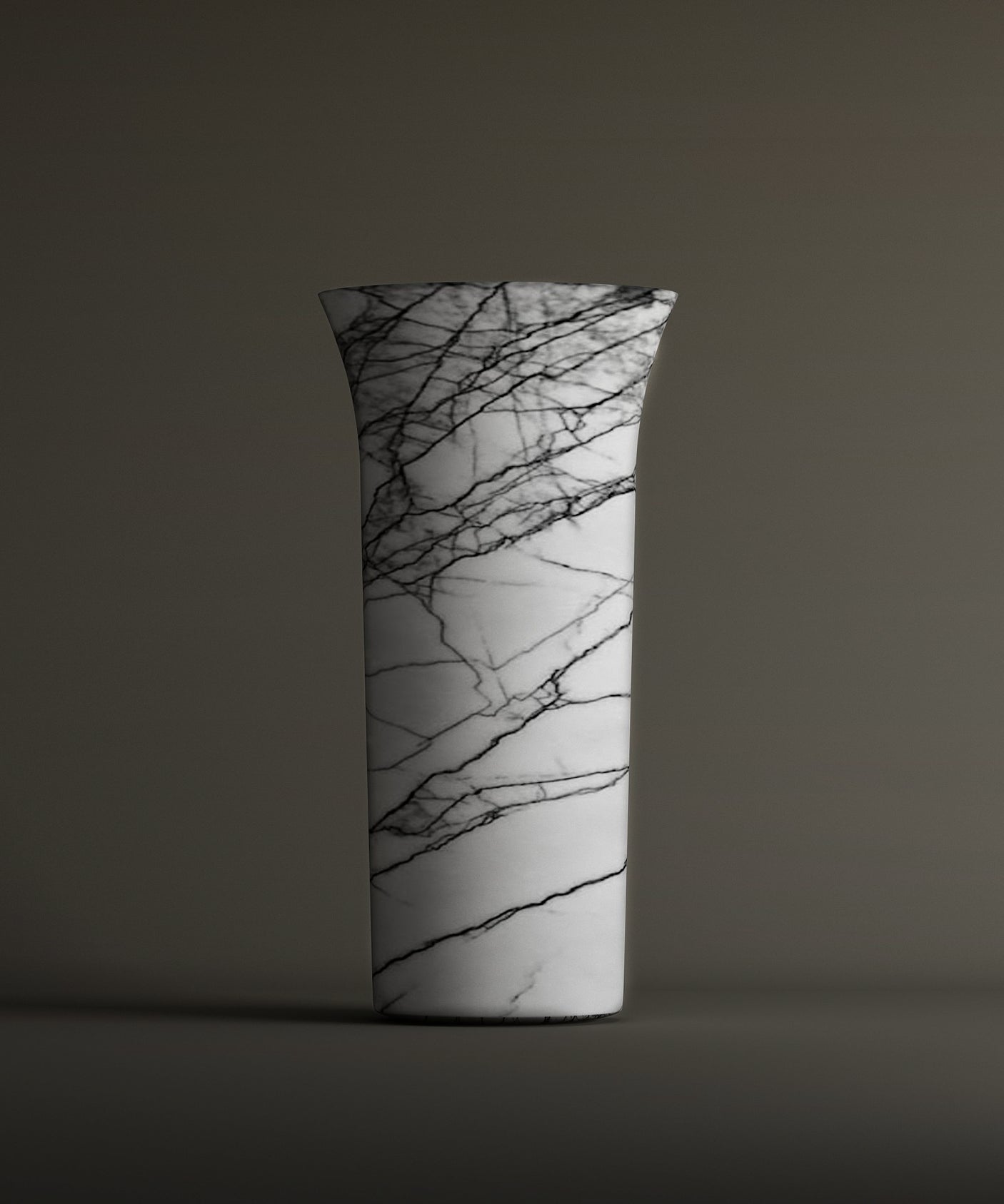 The TRAVERTABLE Lilac Marble Cylinder Pedestal Vanity Sink showcases striking black veining on white marble with a flared rim, set against a plain brownish-gray background.