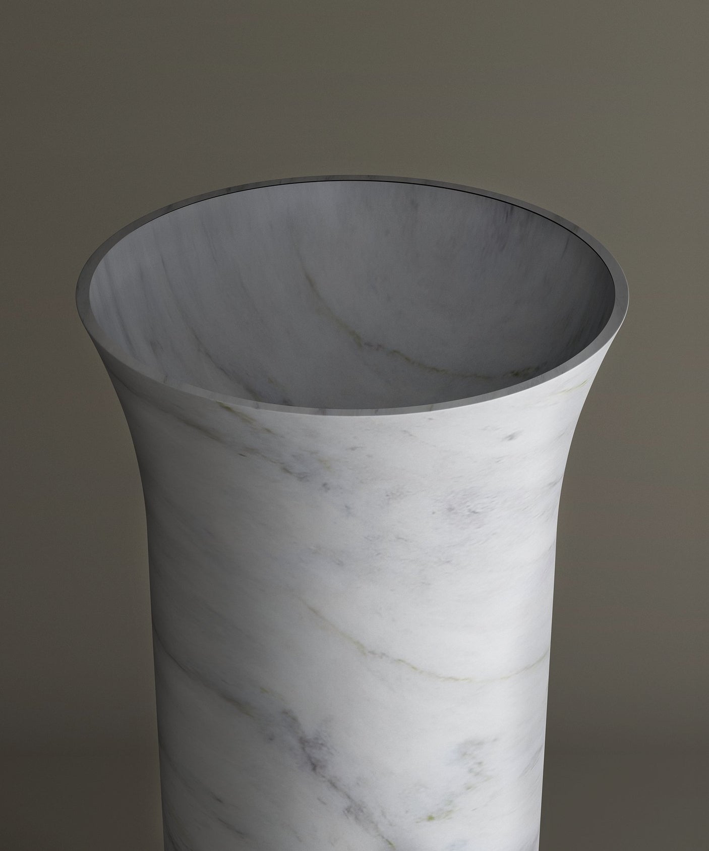 The TRAVERTABLE Carrara Marble Cylinder Pedestal Vanity Sink, featuring flared edges and subtle gray veining, is displayed against a neutral background.
