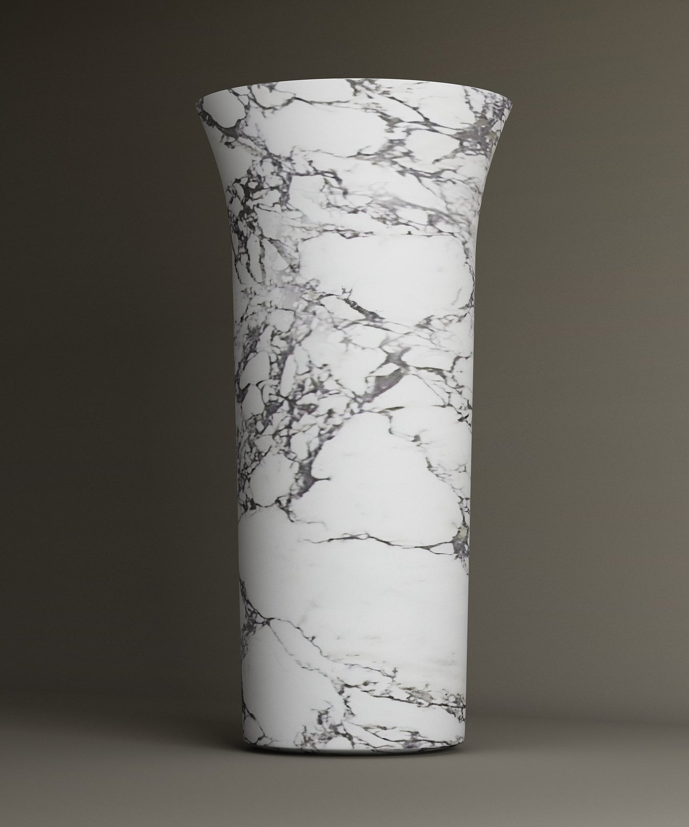 The TRAVERTABLE Calacatta Marble Cylinder Pedestal Vanity Sink features a tall, cylindrical form with gray and black marble-like veining, making an architectural statement against a neutral background.