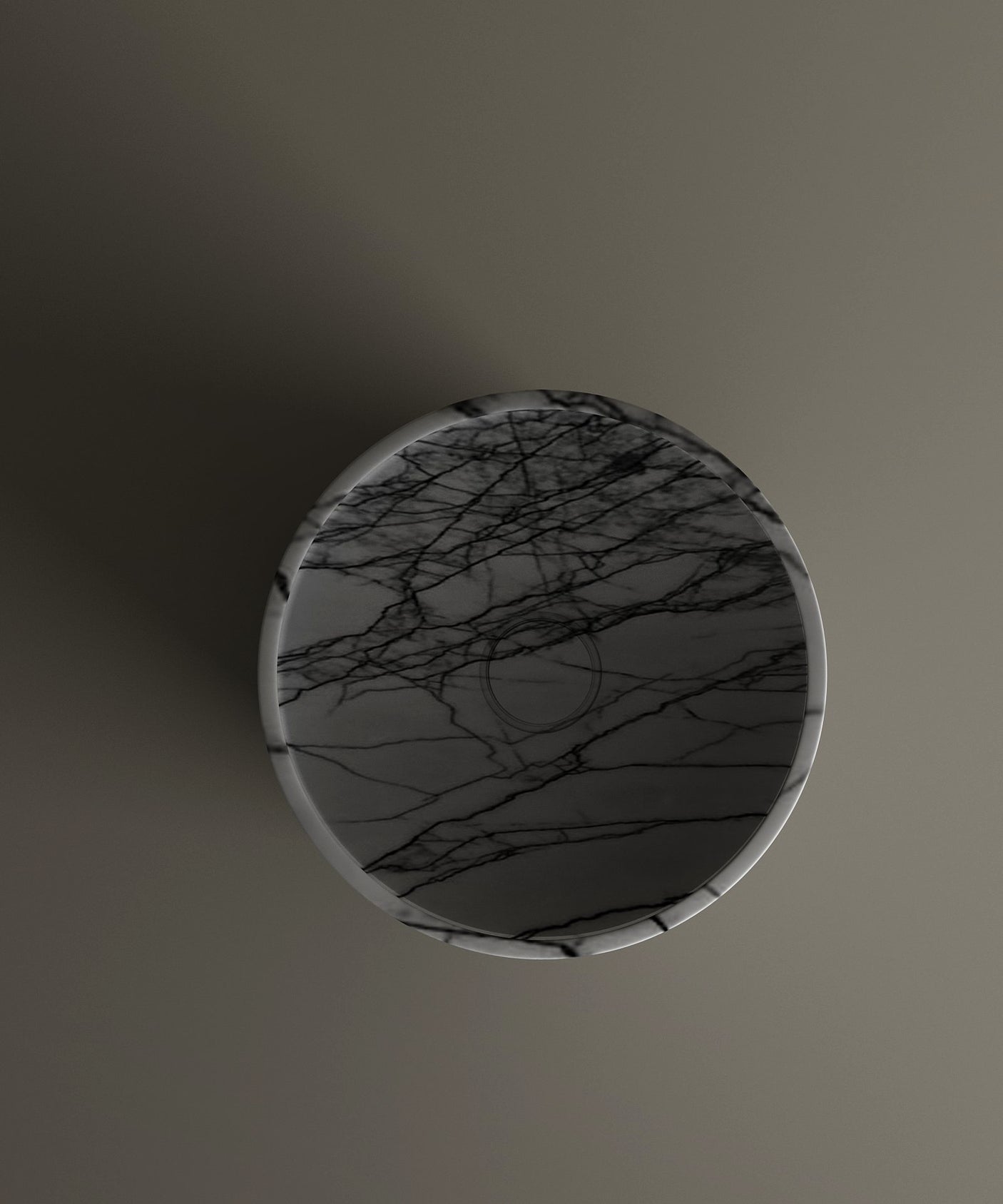 The TRAVERTABLE Lilac Marble Pedestal Vanity Sink features a round design with light and dark veining, pictured from above on a smooth gray surface. The freestanding sink casts a subtle shadow to the left.