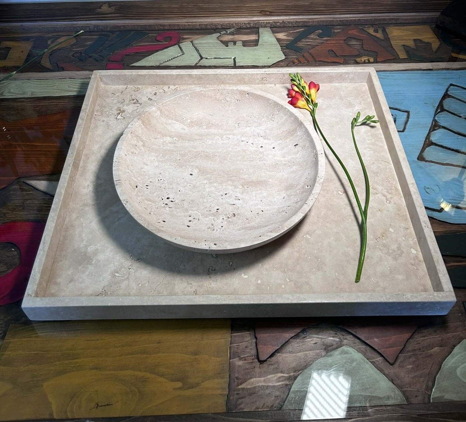 tray and bowl from travertine next to a flower