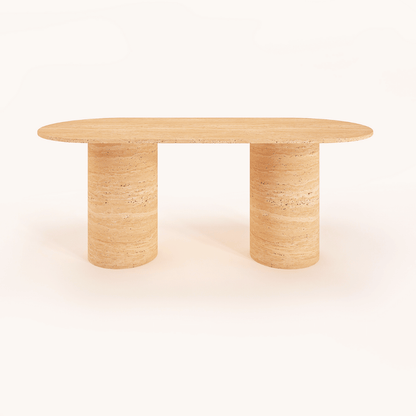 The Arcadia Dining Table by Travertable, an oval-shaped beige stone piece with a natural textured finish, features two cylindrical legs. Minimalistic and set against a white background, it can be customized to match any decor style.