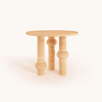 The Opulent Round Travertine Dining Table by Travertable features a round wooden top with three uniquely shaped solid cylindrical legs and varying thicknesses. Its light natural finish stands out against a white background, offering customizable luxury dining options.