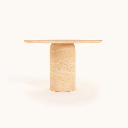 A beige natural-textured Chic Oval Travertine Dining Table by Travertable, featuring a smooth marble surface and cylindrical base, is set against a white background.
