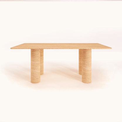 The Columnar Travertine Dining Table by Travertable features a minimalist rectangular top and two cylindrical pillar legs, embodying contemporary design. Its smooth texture and simple elegance are set against a plain white background, with customizable options to suit personal decor styles.