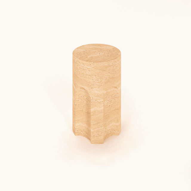 A Handcrafted Travertine Marble Side Table by Travertable, featuring a cylindrical beige design with a smooth top and gently indented sides, set against a plain white background.