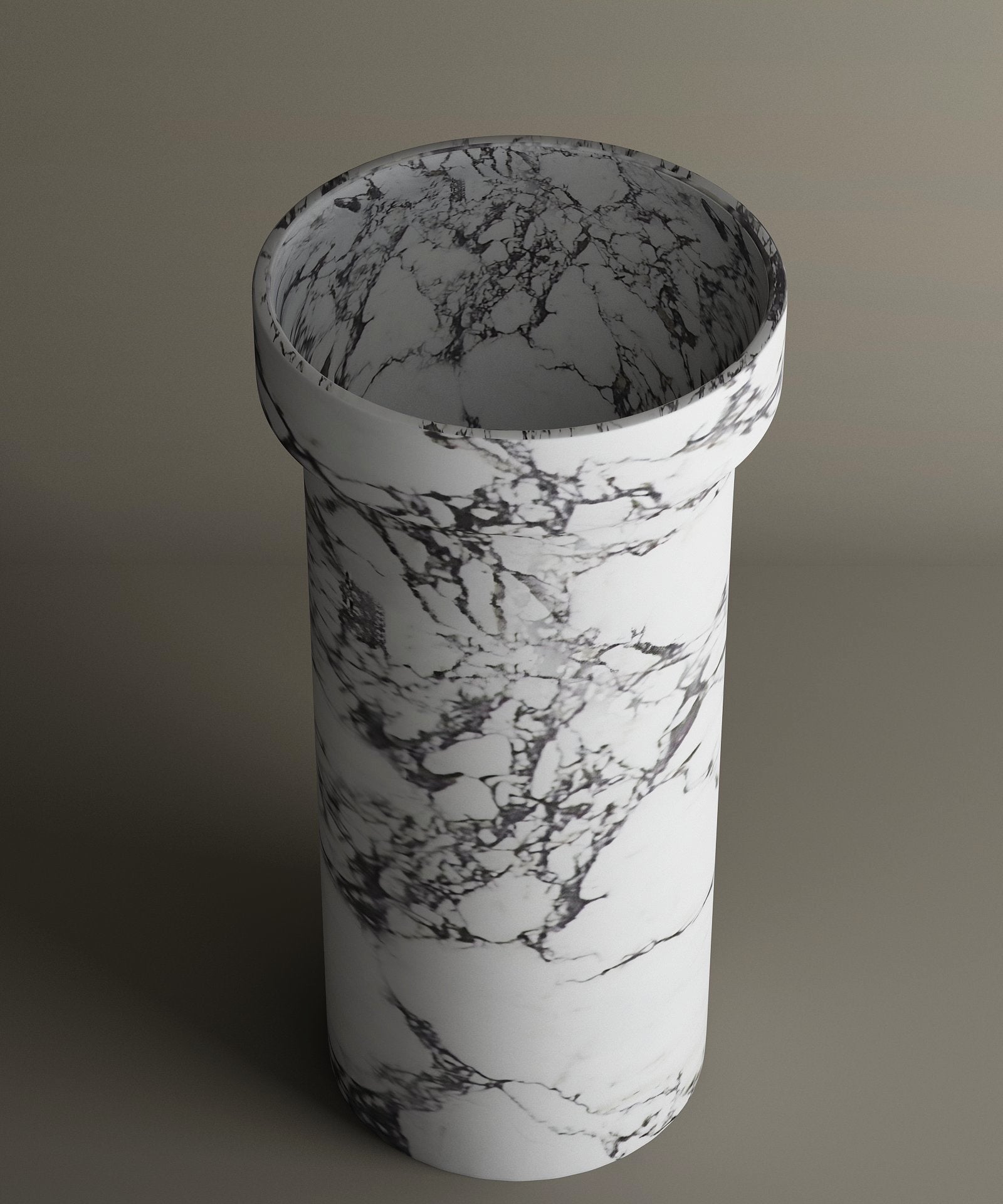 The TRAVERTABLE Calacatta Marble Pedestal Vanity Sink features a white and gray marble pattern, a subtly wider rim, and a timeless cylindrical design inspired by classic pedestal sinks. Shown against a plain background.