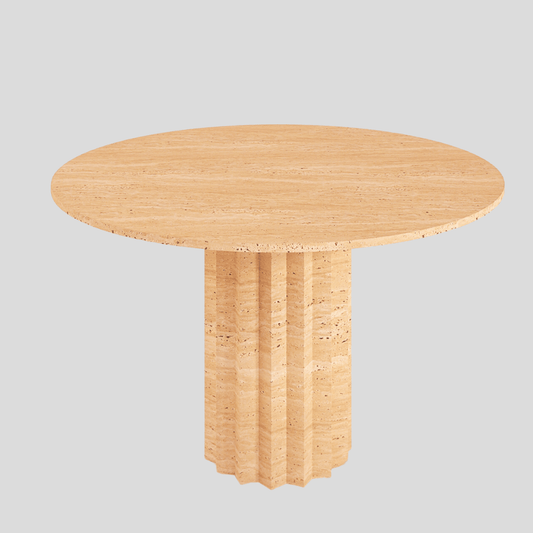 The Fluted Round Travertine Dining Table by Travertable features a smooth, round wooden top and a fluted travertine base, set against a plain gray background.