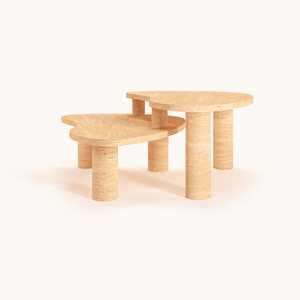 The Travertable Vintage-Inspired Travertine Coffee Table set, with contrasting designs and cylindrical legs, stands elegantly on a seamless background. The taller table creates a tiered effect, highlighting the organic veining and natural authenticity of their rounded tops.