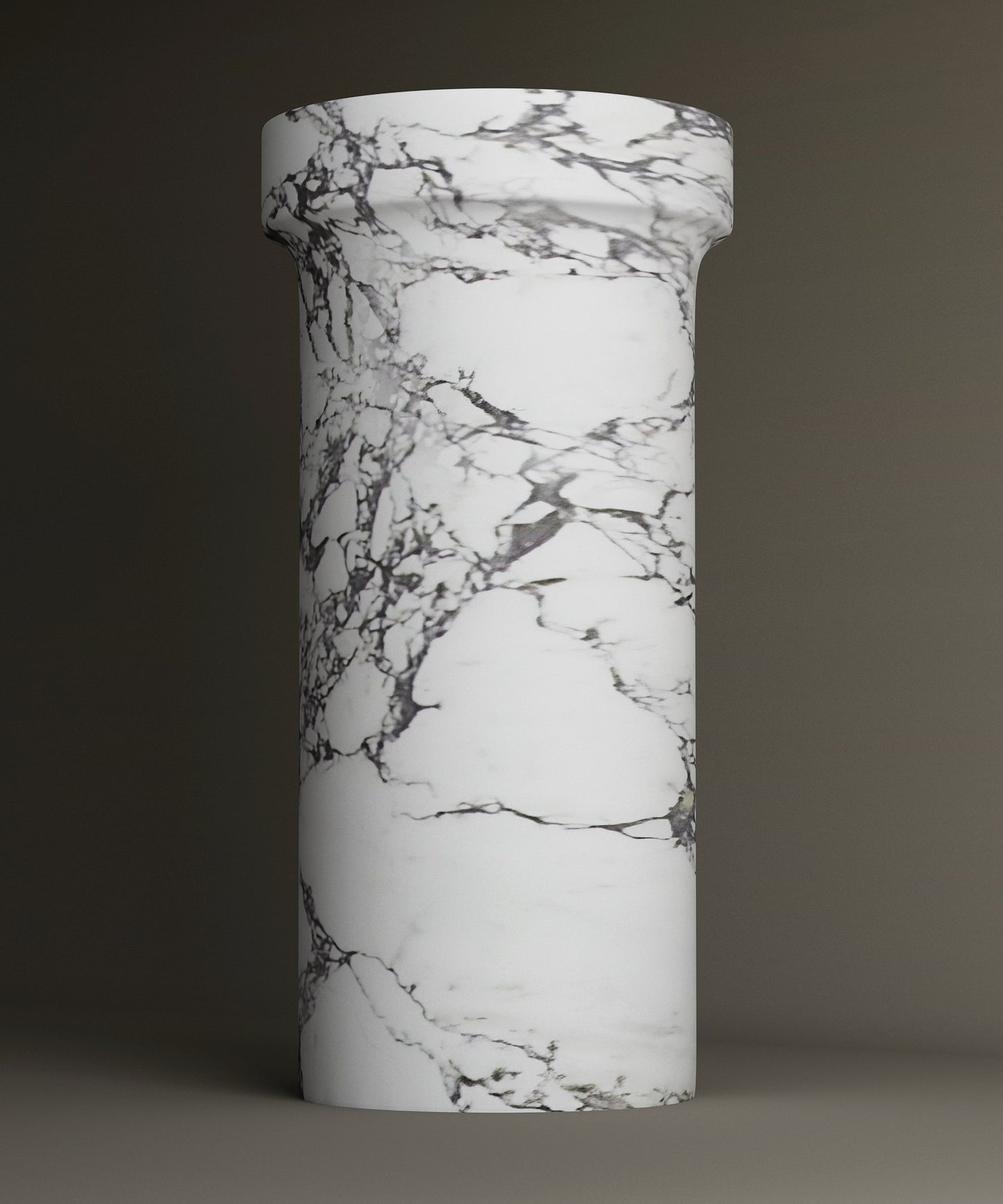 The TRAVERTABLE Calacatta Marble Pedestal Vanity Sink features a tall, cylindrical design with a wider top and elegant gray veining. The plain backdrop accentuates its timeless, sophisticated look.