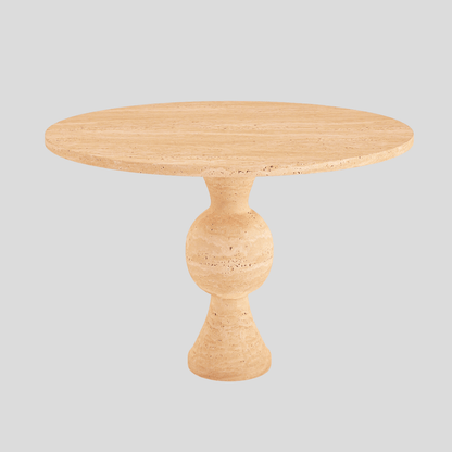 The Hourglass Round Travertine Dining Table by Travertable showcases a smooth, beige stone surface and features a central sculptural base resembling a large, hourglass-like sphere, elegantly set against a plain gray backdrop.