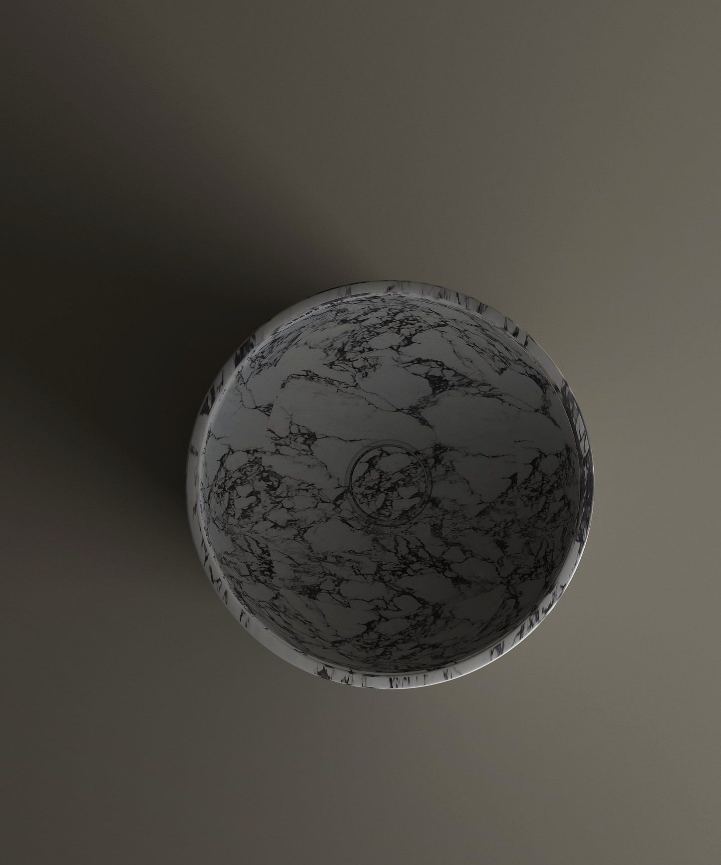 The TRAVERTABLE Calacatta Marble Pedestal Vanity Sink features a round design with a gray and black marbled pattern, viewed from above atop a matte surface that creates a subtle shadow to the left.