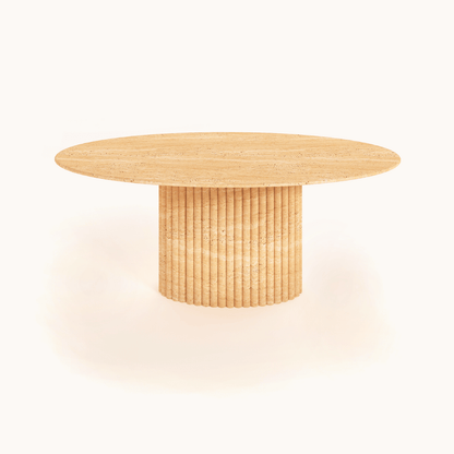 The Elysian Travertine Feast Table by Travertable features an elegant oval design and ribbed pedestal base, elegantly displayed against a plain white background. It offers customization options to match your unique style.
