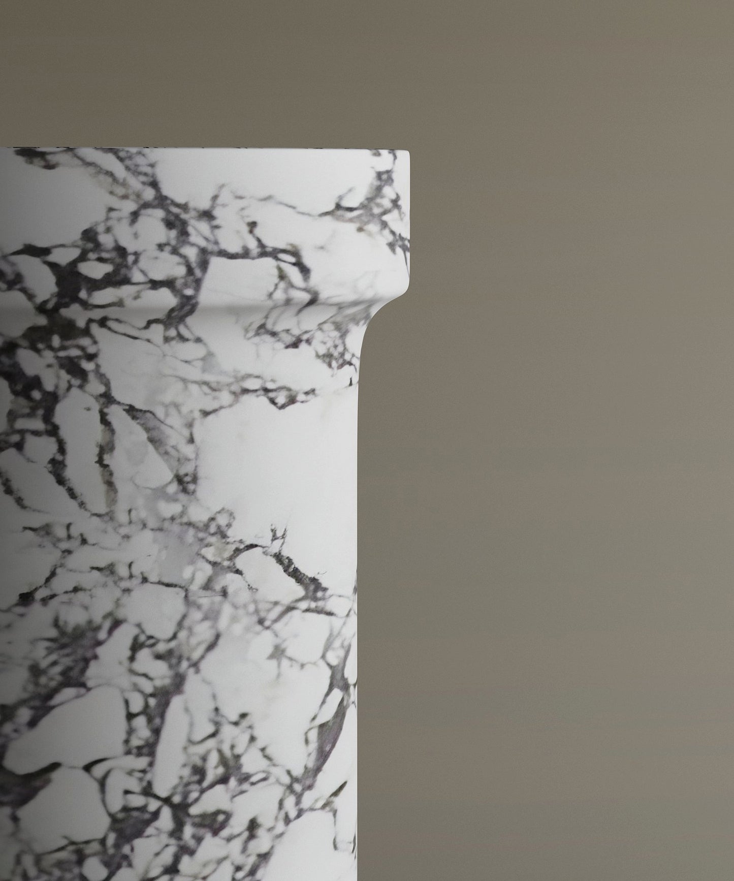 A close-up of the TRAVERTABLE Calacatta Marble Pedestal Vanity Sink with gray veining, shown on the left against a beige background.
