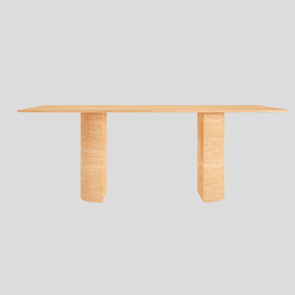 The Travertable Horizon Travertine Dining Table features a sleek rectangular wooden design with a light finish, its flat top supported by two thick legs contrasting against a plain gray background to emphasize its minimalistic elegance.