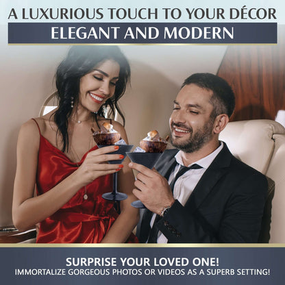 A couple clinks Mamaco Home Large Martini Glasses in an elegant setting. She wears a red dress, he dons a suit. A Luxurious Touch to Your Décor: Elegant and Modern, suggests surprising a loved one with these shatterproof, BPA-free tumblers for home or events.