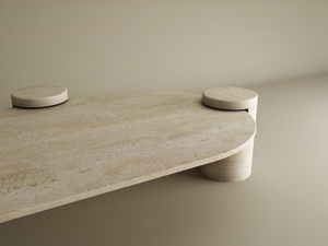 The TRAVERTABLE Oval Travertine Coffee Table with Cylindrical Base features smooth organic lines, a large oval top, and three cylindrical bases. Its natural stone texture and clean design offer modern style. Customizable for your space.