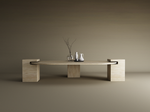 The TRAVERTABLE Oval Travertine Coffee Table with Square Base exudes understated elegance, featuring a minimalist beige stone design. Styled with a glass vase and ceramic pitchers, it sits against a warm neutral beige and brown backdrop. Customizable to fit your space.