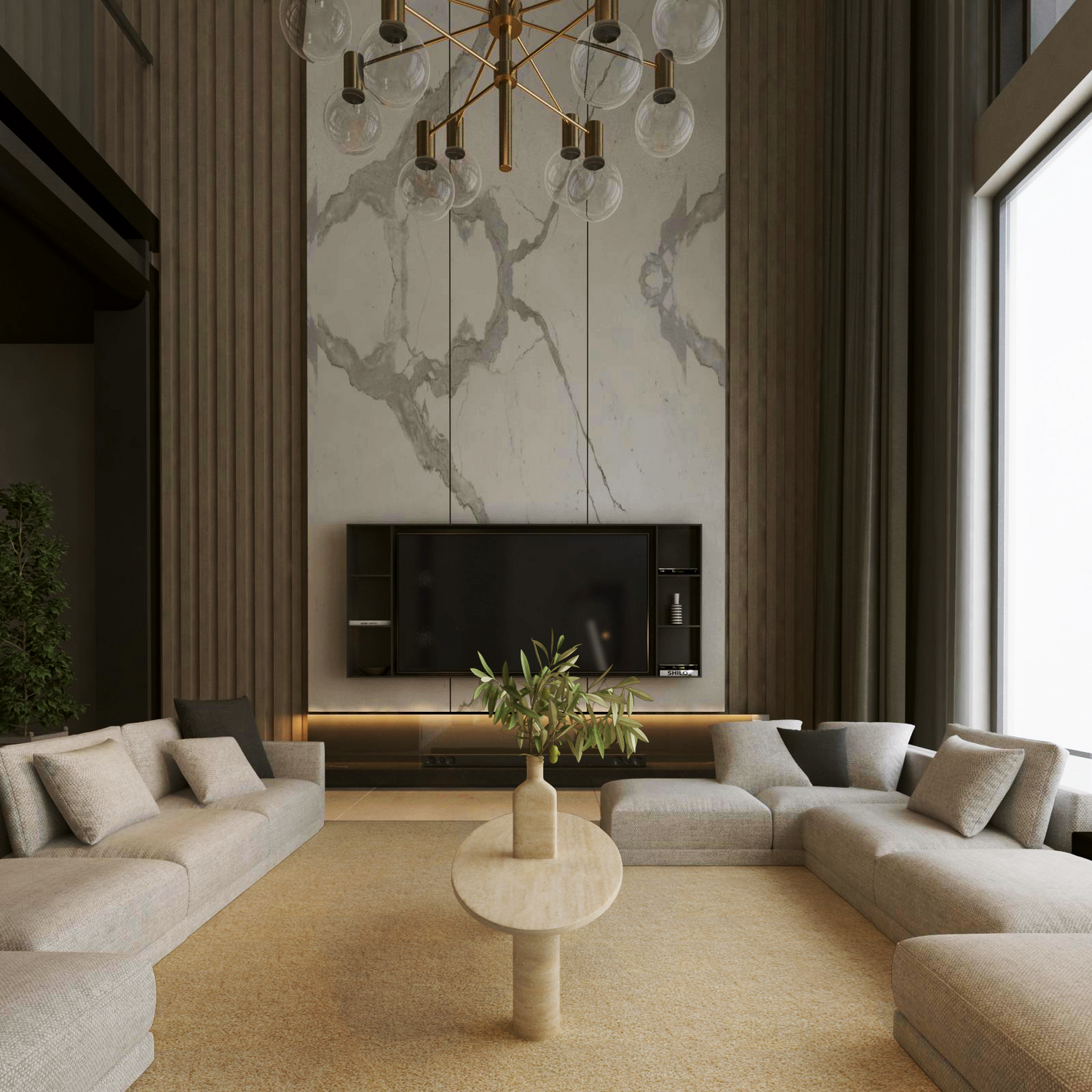 A modern living room with two large beige sectional sofas facing each other, a TRAVERTABLE Ellipse Travertine Coffee Table with Solid Cylindrical Base in the center, a marble accent wall with a mounted TV, and a large window letting in natural light.