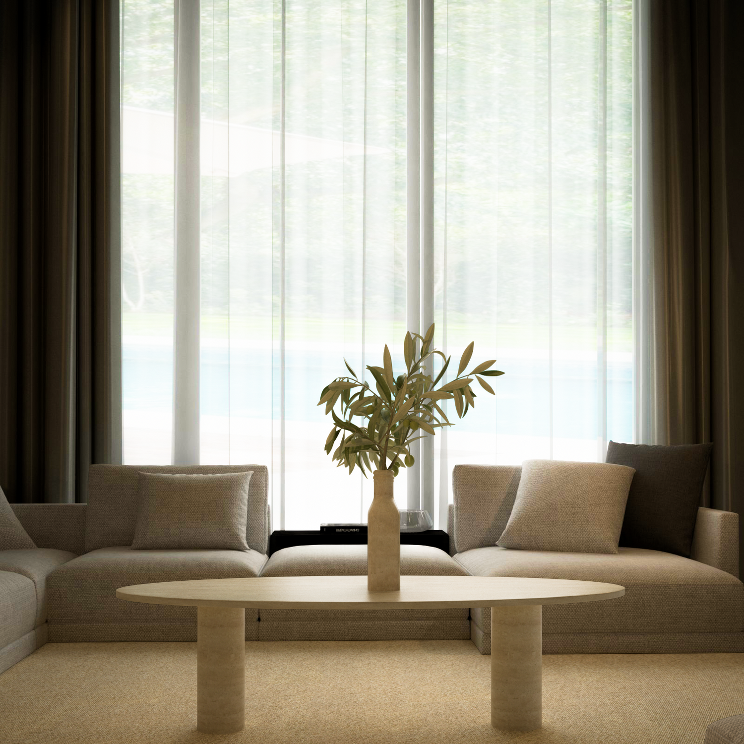 A minimalist living room features two beige sofas, TRAVERTABLEs Ellipse Travertine Coffee Table with a solid cylindrical base, a vase of greenery, and large windows with sheer curtains letting in natural light.