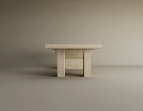 The TRAVERTABLE Architectural Travertine Coffee Table features a sculptural base and thick rectangular top in timeless natural stone, with a minimalist geometric design. Customizable and set against a gradient beige background.