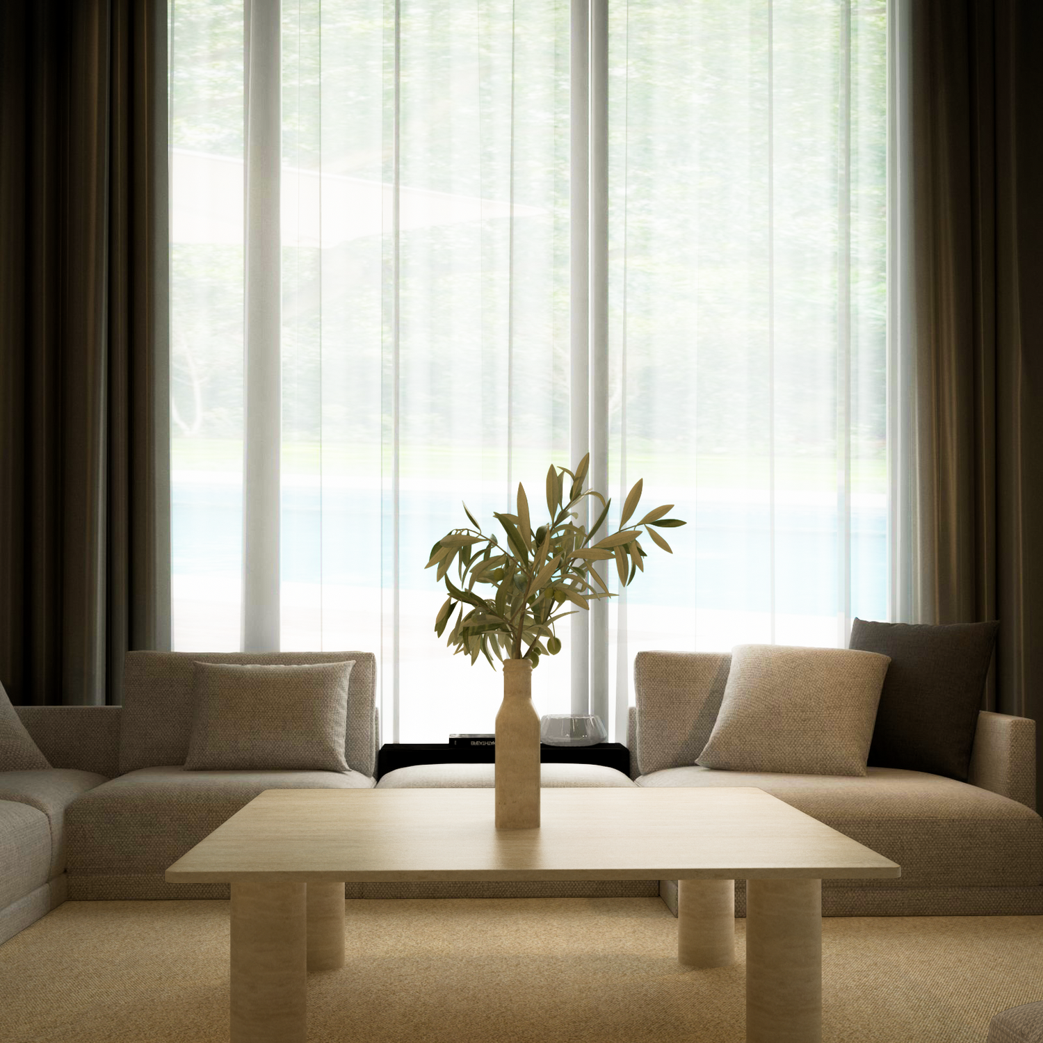 A modern living room featuring two beige sofas, the TRAVERTABLE Square Travertine Coffee Table with Solid Cylindrical Base, a vase with green branches, and large windows with sheer curtains overlooking greenery.