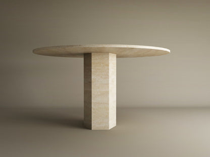 The TRAVERTABLE Oval Travertine Dining Table features a beige stone top and a thick hexagonal center base, highlighting geometric craftsmanship, set against a plain light brown background. Customizable for your dining space.