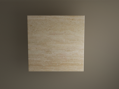 Centered against a plain brown background, the TRAVERTABLE Square Travertine Dining Table features pure travertine stone with hand-finished details and natural veining, highlighting its custom horizontal striations and a cylindrical center base.