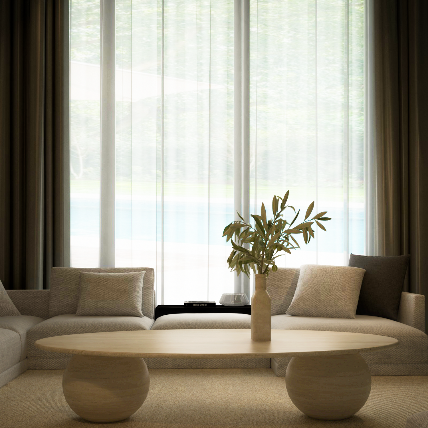 A modern living room featuring TRAVERTABLEs customizable Ellipse Travertine Coffee Table with a sculptural stone ball base, a vase of leafy branches, two cream sofas with neutral cushions, and sheer curtains over a tall window with an outdoor view.