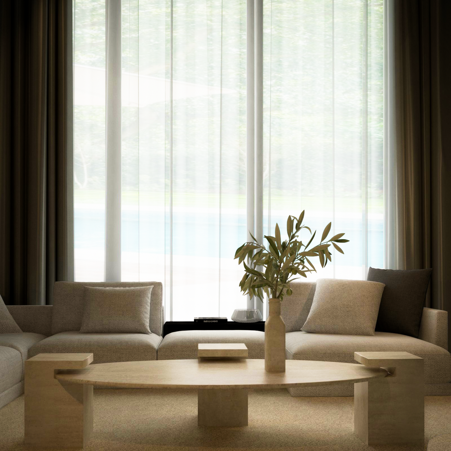A modern living room features a beige sectional, TRAVERTABLE’s customizable Ellipse Travertine Coffee Table with Square Base, and a vase with green branches. Sheer curtains on tall windows let in soft light, highlighting the timeless neutral decor.