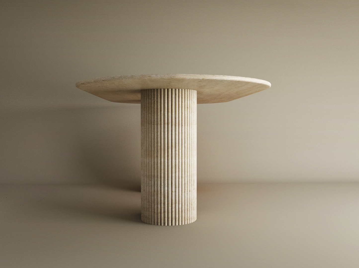 The TRAVERTABLE Oval Travertine Dining Table features a solid, light stone top and a fluted round base, both expertly crafted from natural travertine—an heirloom-quality centerpiece that’s customizable to your space.