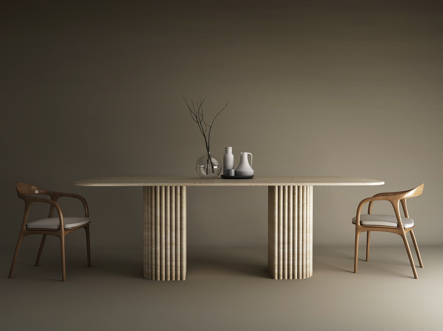 A minimalist dining scene features the TRAVERTABLE Rectangular Travertine Dining Table with Fluted Round Base, solid travertine stone base, two wooden chairs with light cushions, and simple vases with a branch centerpiece against a neutral backdrop.