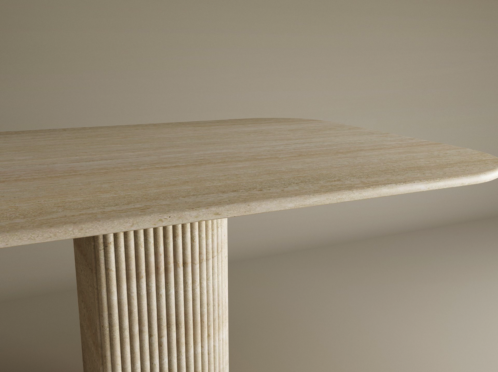 The TRAVERTABLE Rectangular Travertine Dining Table showcases a fluted round solid stone base and smooth tabletop, blending minimalist elegance and heirloom quality in a customizable design against a neutral backdrop.
