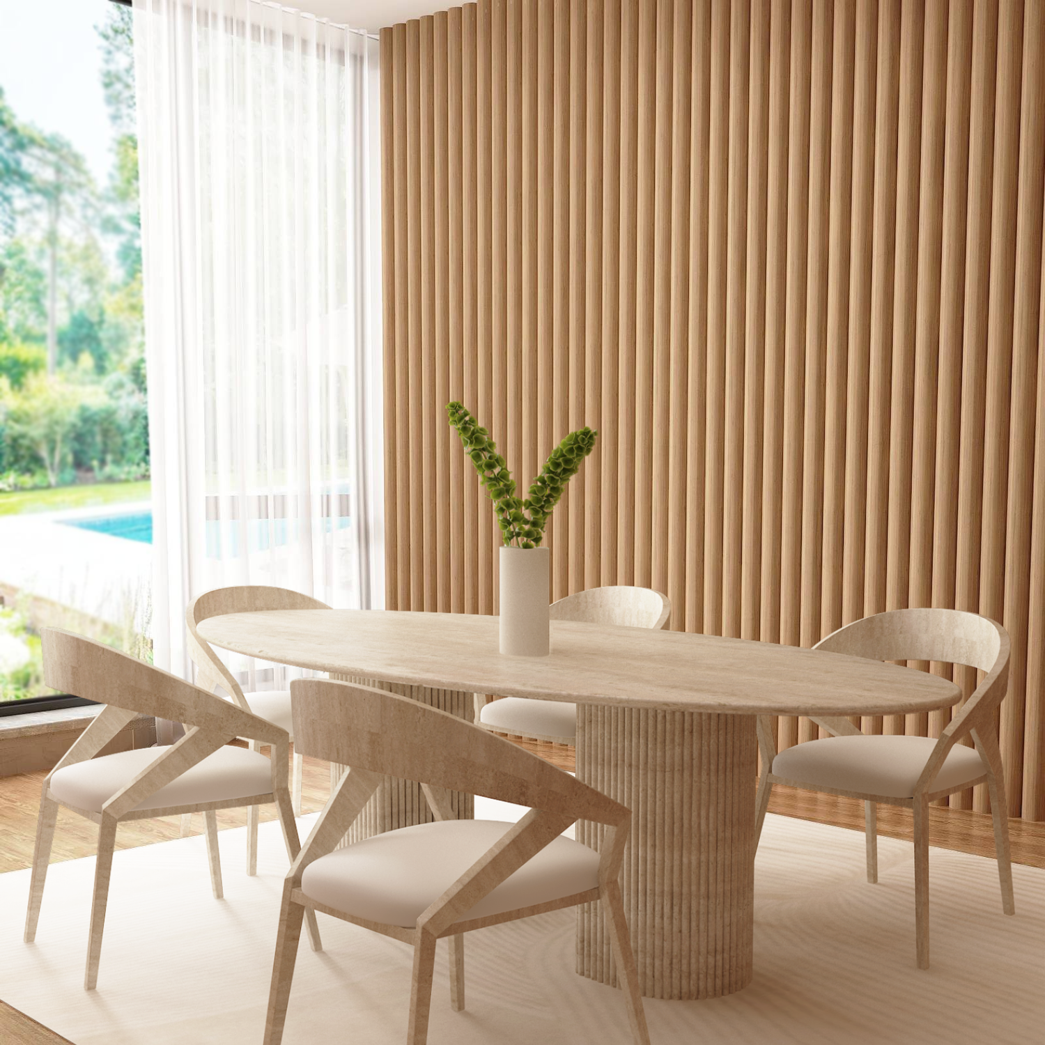 A modern dining room showcases the TRAVERTABLE Ellips Travertine Dining Table with a fluted round solid stone base, four chairs, a white rug, vertical wood panels, and a vase with greenery. Large windows frame sunny views of greenery and a pool.