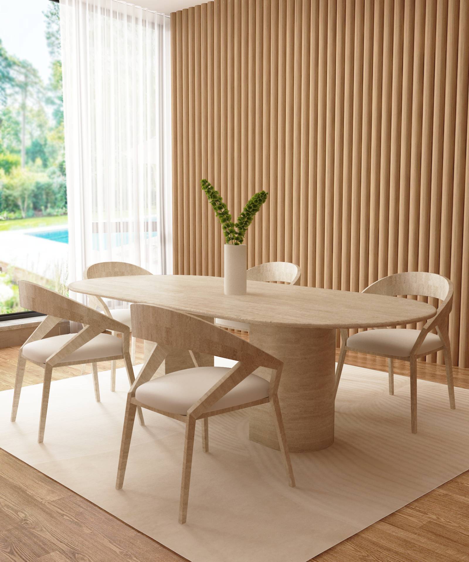 A modern dining room with a TRAVERTABLE Oval Travertine Dining Table featuring a sloped pedestal base, four matching chairs, white area rug, white vase with greenery, wood slat wall, and large window overlooking lush views.