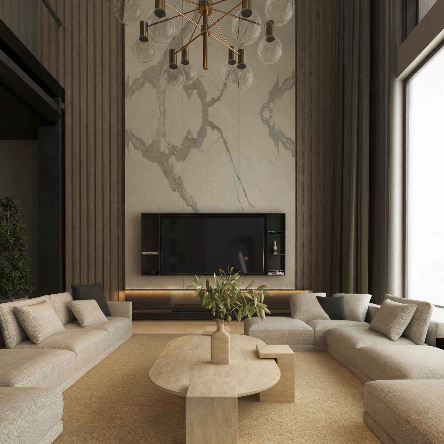 A modern living room exudes understated elegance with two beige sectionals facing the TRAVERTABLE Oval Travertine Coffee Table with Square Base. A marble-accented wall holds a large TV, flanked by shelves, under a gold chandelier. Big windows invite natural warmth.