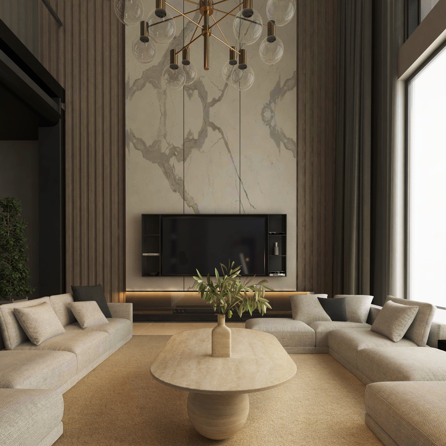 A modern living room features TRAVERTABLEs Oval Travertine Coffee Table with Stone Ball Base – Artistic Travertine – Customizable, surrounded by beige U-shaped sofas, a marble accent wall with TV, tall windows, and a gold chandelier under high ceilings.