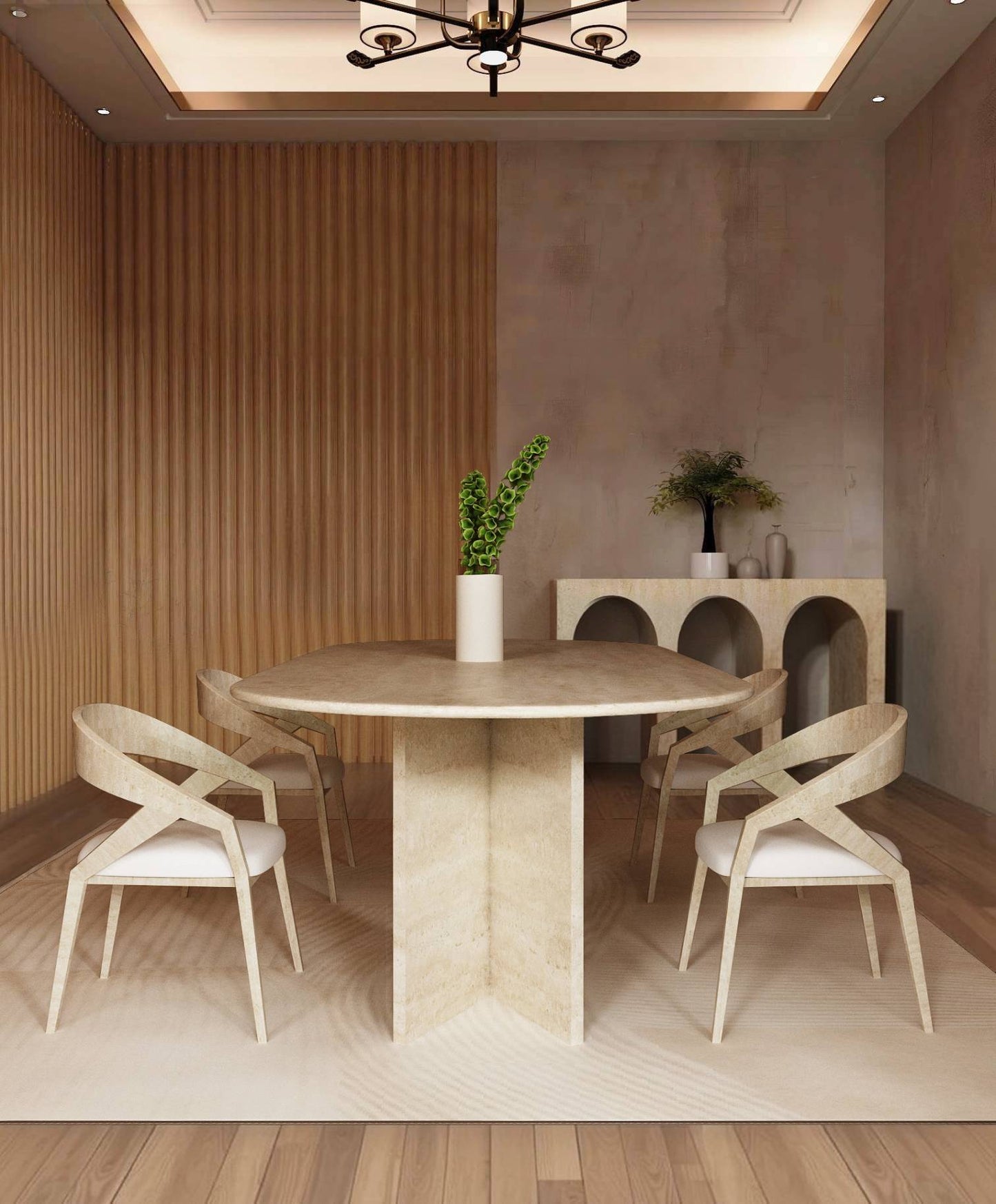 A modern dining room showcases the TRAVERTABLE Oval Travertine Dining Table with Split-V Pedestal Base, paired with four light wood chairs, a central vase of green leaves, and a console table displaying plants and decor by wooden paneling.