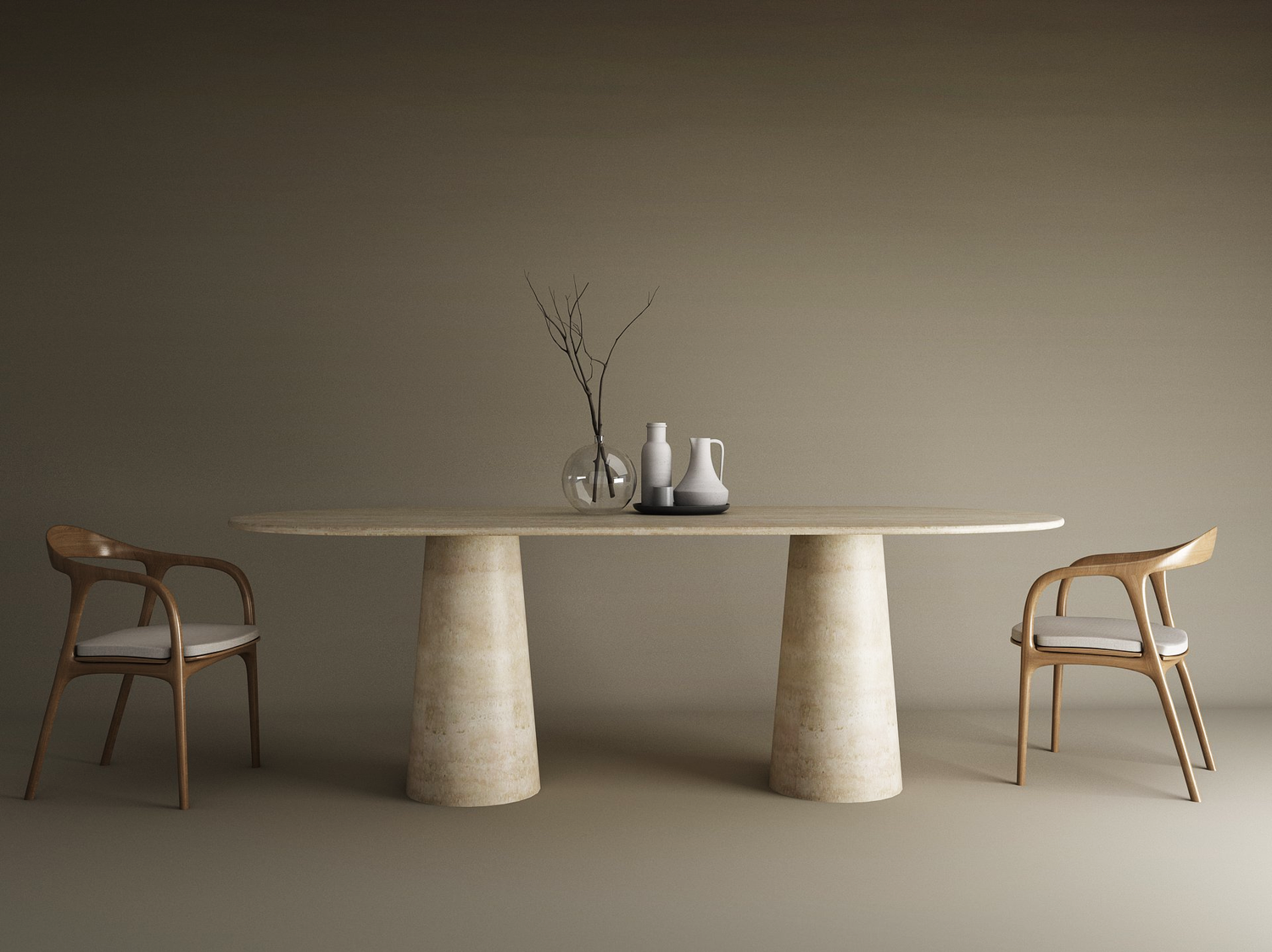 The TRAVERTABLE Oval Travertine Dining Table with a conical stone base stands between two wooden chairs with white cushions. On the natural stone top are a glass vase with bare branches and two white ceramic pitchers, set against a beige background.